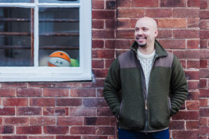 A photo of Chris Adriaanse standing and smiling